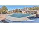 Community pool with cover, surrounded by a patio and pergola at 5726 N Genoa Way # 10-106, Aurora, CO 80019