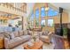 Open living room with vaulted ceilings, kitchen, and mountain views at 32155 Edward Dr, Conifer, CO 80433