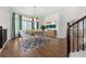 Bright dining room with hardwood floors and modern light fixture at 5049 Liverpool St, Denver, CO 80249