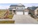 Two-story home with attached garage and landscaping at 5049 Liverpool St, Denver, CO 80249