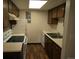 Galley kitchen with wood cabinets and modern appliances at 2231 Sable Blvd # 912, Aurora, CO 80011