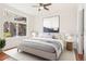 Bright bedroom with large window, hardwood floors, and ceiling fan at 3601 Arapahoe Ave # 226, Boulder, CO 80303