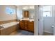 Main bathroom with double vanity and a soaking tub at 2386 Creek Valley Cir, Monument, CO 80132