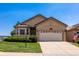 Tan single-story house with a two-car garage and American flag at 2386 Creek Valley Cir, Monument, CO 80132