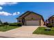 Tan two-story house with a two-car garage and landscaped yard at 2386 Creek Valley Cir, Monument, CO 80132