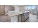 Modern kitchen island with white quartz countertops and stainless steel appliances at 16728 W 93Rd Pl, Arvada, CO 80007
