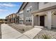 Townhome exterior showcasing gray siding, a covered entryway, and landscaping at 16728 W 93Rd Pl, Arvada, CO 80007