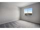 Bright bedroom with carpeted floor and a view at 16728 W 93Rd Pl, Arvada, CO 80007