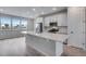 Modern kitchen with white cabinets, stainless steel appliances, and an island at 16728 W 93Rd Pl, Arvada, CO 80007