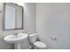 Clean and modern powder room with pedestal sink and toilet at 16728 W 93Rd Pl, Arvada, CO 80007