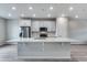 Kitchen island with white quartz countertop and gray cabinets at 16728 W 93Rd Pl, Arvada, CO 80007
