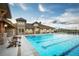 Community pool with lounge chairs and mountain views at 16728 W 93Rd Pl, Arvada, CO 80007