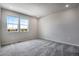Spacious bedroom with two windows and grey carpeting at 16728 W 93Rd Pl, Arvada, CO 80007