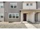 Townhome's front entrance with a dark brown door and a covered porch at 16728 W 93Rd Pl, Arvada, CO 80007
