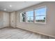 Bright living room with large windows and gray tone laminate flooring at 16728 W 93Rd Pl, Arvada, CO 80007