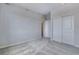 Spacious bedroom with double doors leading to the bathroom at 16728 W 93Rd Pl, Arvada, CO 80007