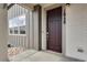 Modern dark brown front door with a sleek handle and house numbers at 16728 W 93Rd Pl, Arvada, CO 80007