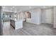 Modern kitchen featuring a large island, white cabinets, and gray flooring at 16728 W 93Rd Pl, Arvada, CO 80007