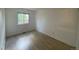 Well-lit bedroom featuring wood-look floors and a window at 3581 S Olathe St, Aurora, CO 80013