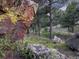 Rocky landscape with trees and greenery at 63 Canyon Pines Dr, Arvada, CO 80403