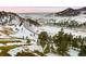 Aerial view of a winding road and snowy landscape at 63 Canyon Pines Dr, Arvada, CO 80403