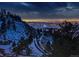 Night view of city lights from a snow-covered hilltop at 63 Canyon Pines Dr, Arvada, CO 80403