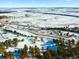 Aerial view of snow-covered land with sparse trees at 63 Canyon Pines Dr, Arvada, CO 80403