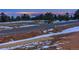Residential lot with mountain and city views at dusk at 63 Canyon Pines Dr, Arvada, CO 80403
