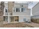 Light beige siding townhouse exterior with stone accents and sliding glass door at 11103 E Alameda Ave # 102, Aurora, CO 80012