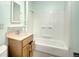 Bathroom with shower/tub combo and wood vanity at 4130 S Acoma St, Englewood, CO 80110