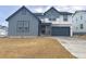 Two-story home with gray and white siding, and a two-car garage at 988 Congress Pl, Elizabeth, CO 80107