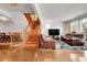 Bright living room, hardwood floors, staircase, and dining area view at 11911 E Canal Dr, Aurora, CO 80011