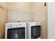 Laundry room with side-by-side washer and dryer and overhead shelving at 6069 W Utah Ln, Lakewood, CO 80232