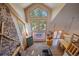 Upstairs view of the main living area with vaulted ceilings and stone fireplace at 6929 Weasel Way, Evergreen, CO 80439