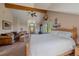 Main bedroom with sitting area, a large bed, and mountain views at 6929 Weasel Way, Evergreen, CO 80439