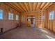 Unfinished barn interior with wood framing and windows at 6929 Weasel Way, Evergreen, CO 80439