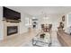 Living room with a fireplace, glass coffee table, and kitchen view at 50 19Th Ave # 84, Longmont, CO 80501