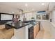 Basement wet bar with granite countertop, sink, and cabinetry at 7646 S Yampa St, Centennial, CO 80016