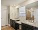 Double vanity bathroom with granite countertops and a shower at 26346 E Canal Pl, Aurora, CO 80018