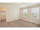 Well-lit bedroom with neutral carpeting and a walk-in closet at 26346 E Canal Pl, Aurora, CO 80018