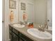 Double vanity bathroom with dark cabinets and granite countertops at 26346 E Canal Pl, Aurora, CO 80018