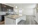 Modern kitchen with island and stainless steel appliances at 26346 E Canal Pl, Aurora, CO 80018