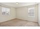 Bright bedroom with neutral carpeting and two windows at 26346 E Canal Pl, Aurora, CO 80018