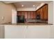 Kitchen features granite counters and breakfast bar at 2500 E Cherry Creek South Dr # 414, Denver, CO 80209