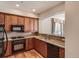Modern kitchen with granite countertops and wood cabinets at 2500 E Cherry Creek South Dr # 414, Denver, CO 80209
