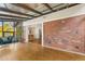 Sunroom with brick wall, glass ceiling, and view into dining area at 3872 S Xanthia St, Denver, CO 80237