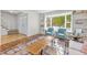 Living room with hardwood floors, built-in shelving, and a view into the entryway at 3872 S Xanthia St, Denver, CO 80237