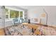 Cozy living room featuring hardwood floors, built-in shelving, and a bay window at 3872 S Xanthia St, Denver, CO 80237