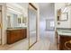 Bathroom with dual vanities, a large mirror, and carpeted floors at 13901 E Marina Dr # 109, Aurora, CO 80014