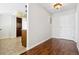 Entryway with hardwood floors, a view of the kitchen, and a white door at 13901 E Marina Dr # 109, Aurora, CO 80014